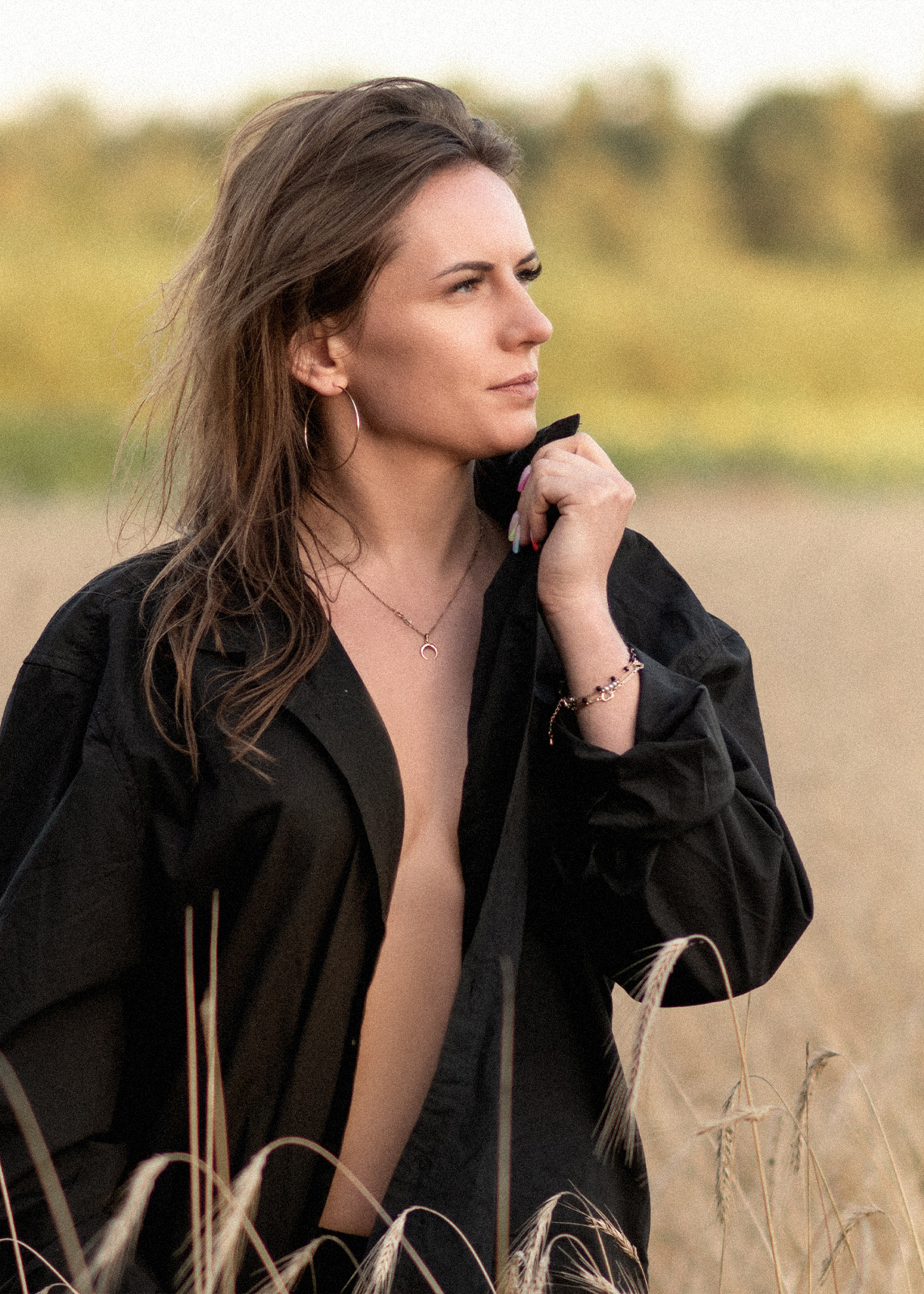 Brunette woman looking into the distance in warm evening light.